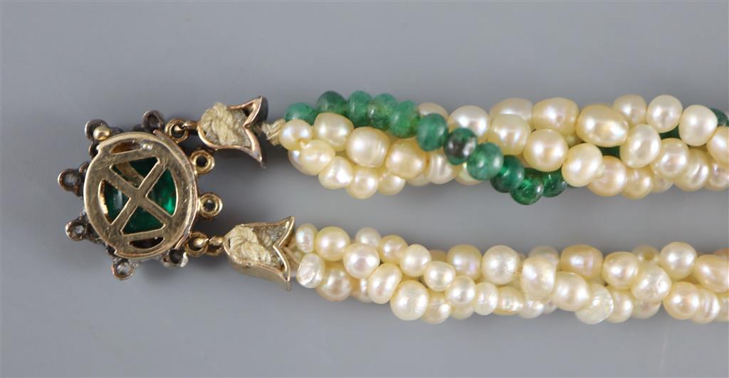 An early 20th century interwoven seed pearl and emerald bead bracelet, with foil backed emerald and diamond cluster set gold clasp,